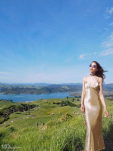 City style and living magazine Editors Notebook style fashion blogger Shivana M Mercury Bay Winery Coromandel New Zealand Gold dress overlooking the ocean
