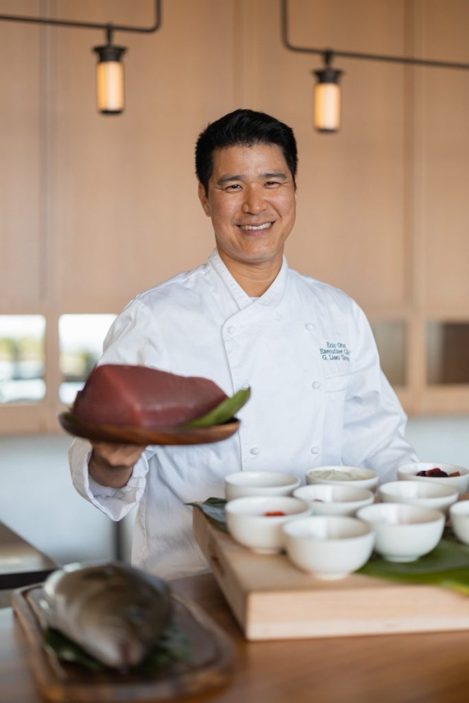 Chef Oto smiles holding tuna at Ritz Carlton Residences Waikiki