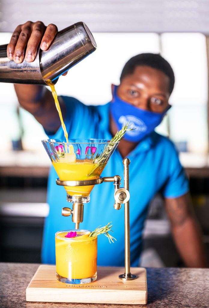 A barman pours a colourful drink at Divi Southwinds Beach Resort Barbados