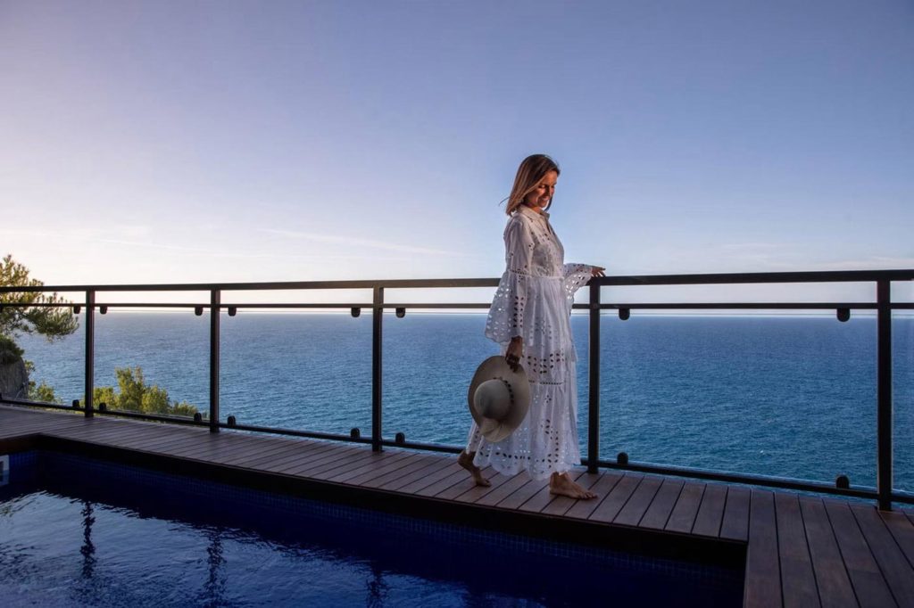 City Style and Living Summer 2023 The Hottest Summer European Escapes Jumeirah Port Sóller Hotel & Spa woman walking at sunset