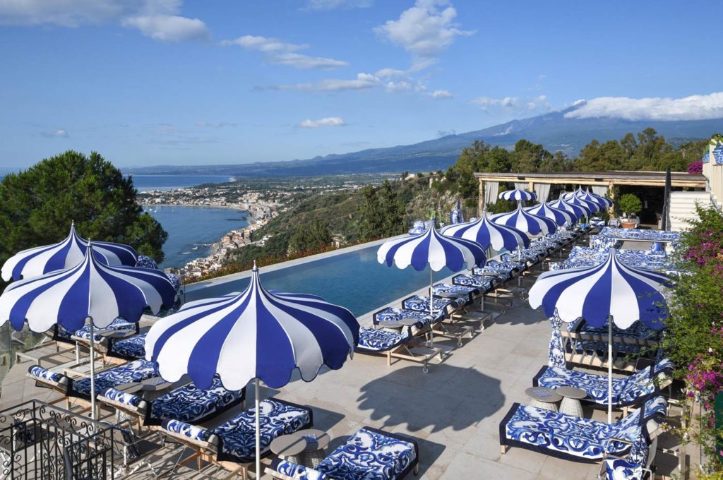 City Style and Living Summer 2023 Dolce&Gabbana Casa San Domenico Palace, Taormina, A Four Seasons Hotel lounge chairs and pool aerial