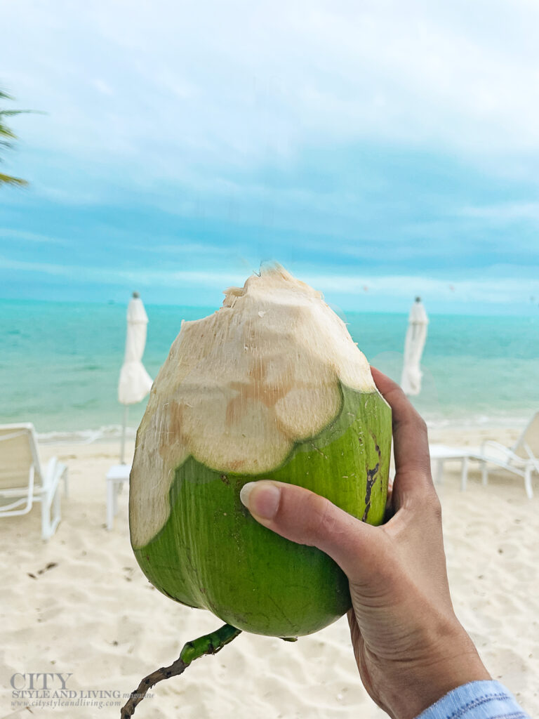 City Style and Living Magazine Spring 2025 Turks and Caicos Hand holding coconut at The Shore Club