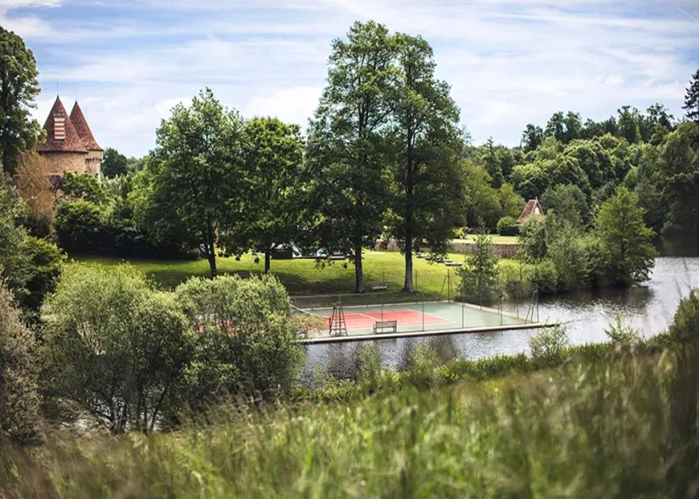 City Style and Living Magazine Winter 2025 Hotel with a Floating Tennis Court Domaine Les Etangs Auberge Collection lush green landscape